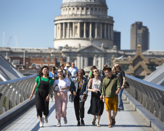 A group students walking together on a bridge