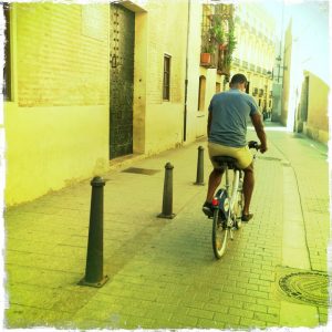 Picture of a Black man cycling.