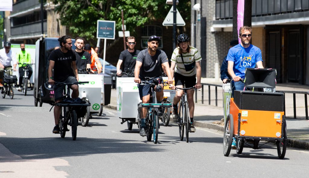 A group of people on cargo bikes on a quiet London street

