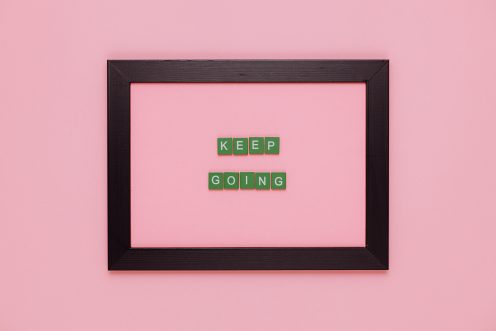 Text on a pink background saying "Keep Going"