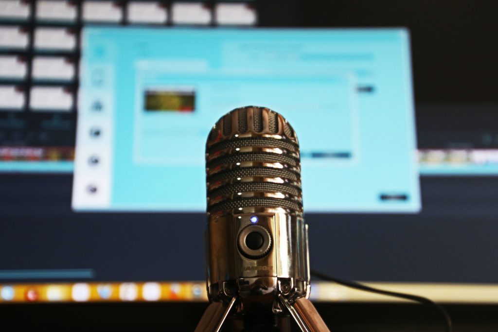 Microphone centre screen with a blurred Laptop screen in the background