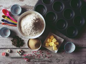 Table top with a mixture of baking ingredients on it - butter, flour, sugar. Photo by Suzy Hazelwood from Pexels