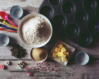 Table top with a mixture of baking ingredients on it - butter, flour, sugar. Photo by Suzy Hazelwood from Pexels
