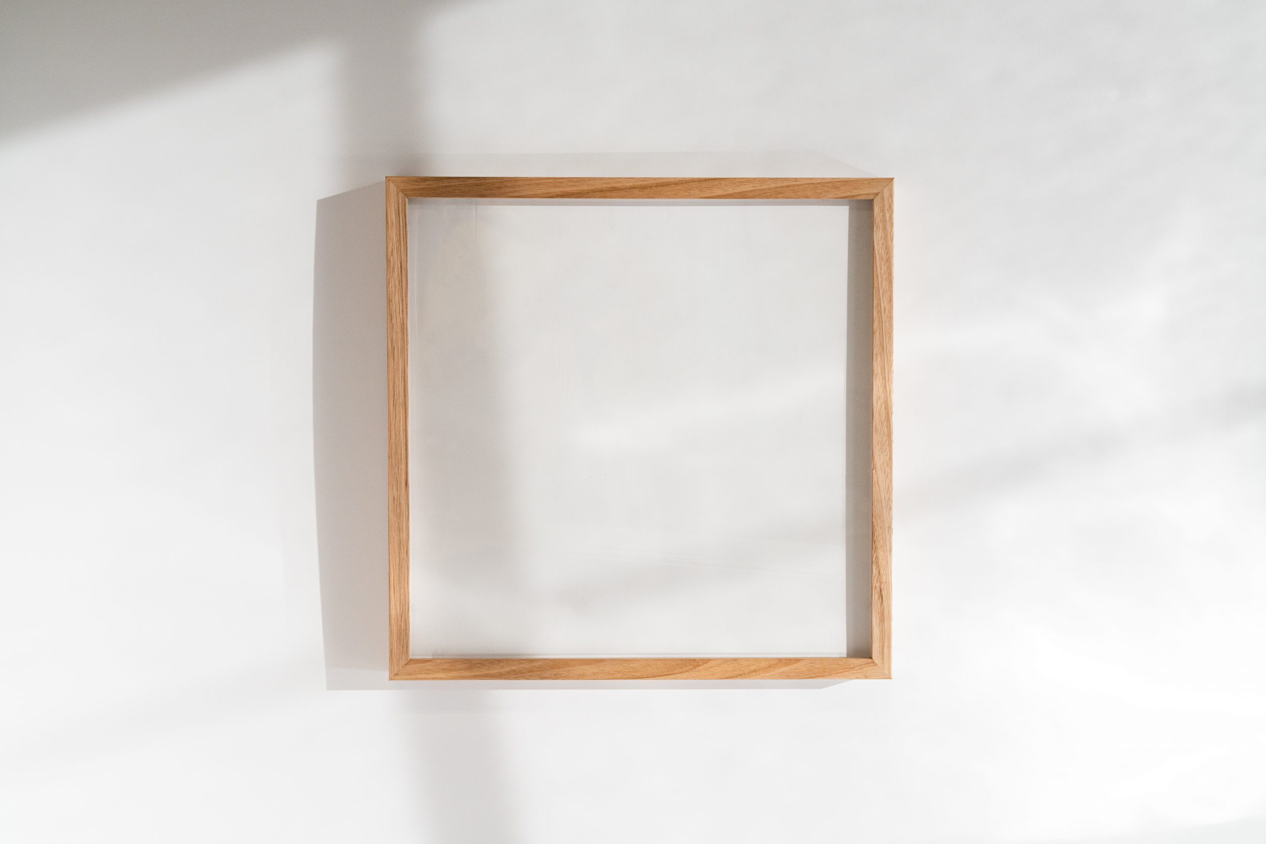 Square Oak Picture Frame on a blank white wall