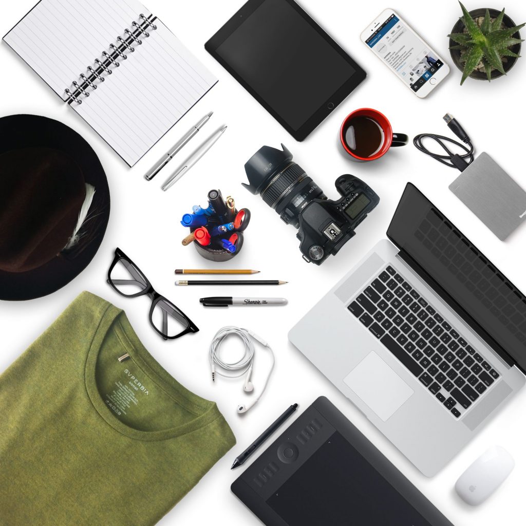 Various items such as laptop, camera, phone, notebook, pen and a pair of glasses to show various skills.