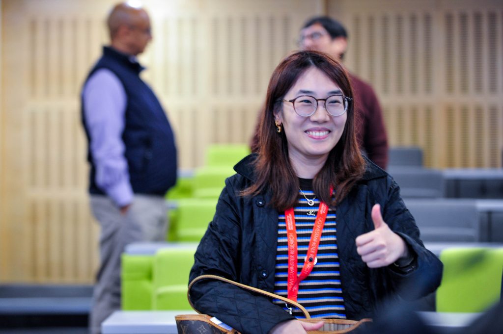 A smiling delegate with a thumbs-up.