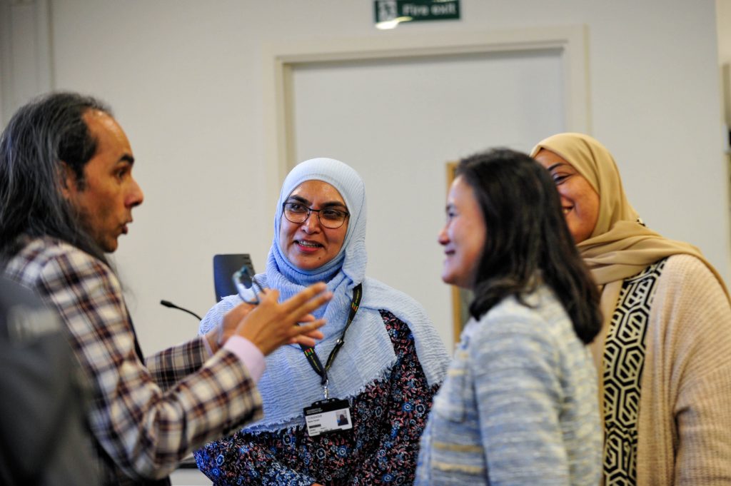 Colleagues networking during the conference.