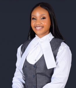 Olivia smiling dressed in business attire - 7 Lessons about Returning to Study a Postgraduate Degree_International Student Blog-Olivia Nzomo