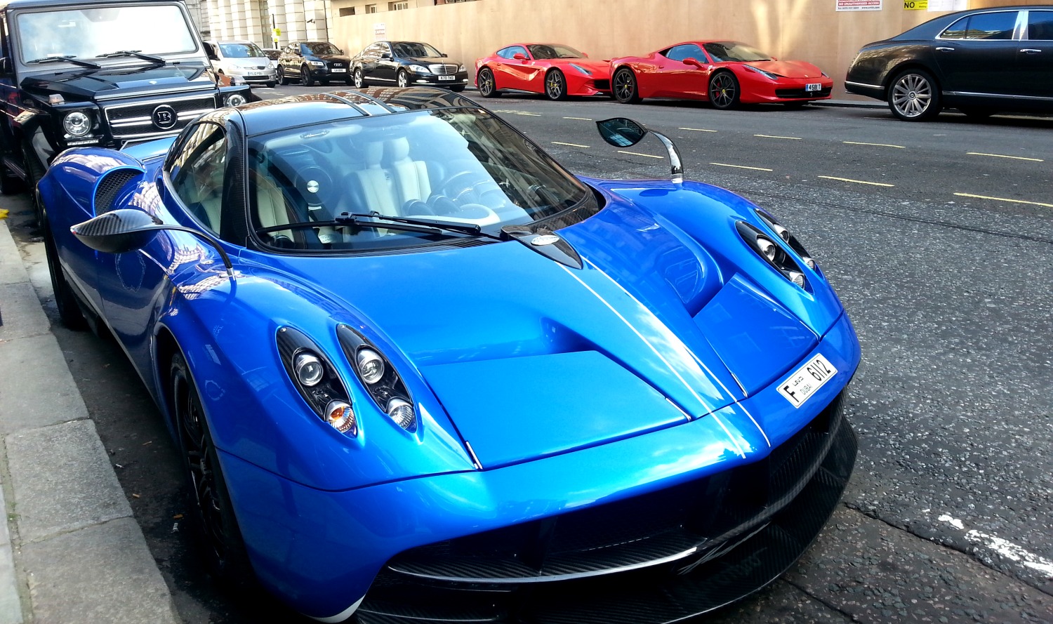 Sloane Street, London, UK, 20th July 2018. A red Porsche sportscar gets a  lot of attention. Supercars, high-performance and classic cars, as well as  some characterful adaptions, line up and drive along