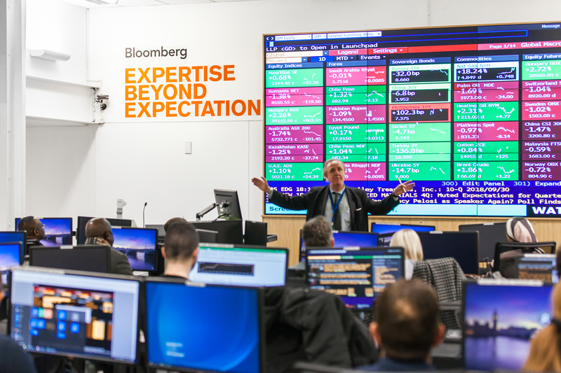 Bloomberg Financial Markets Suite (FMS) Lecturer presenting from display screen and students at Bloomberg terminals