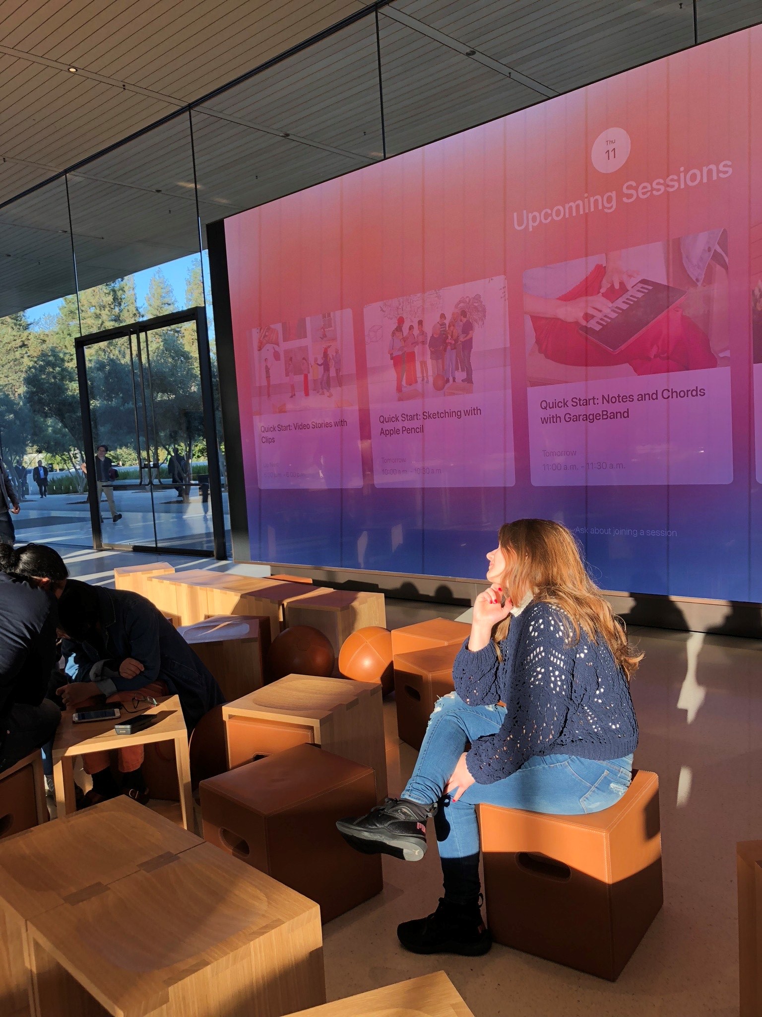 Shejla inside Apple Park with smartscreen in the background