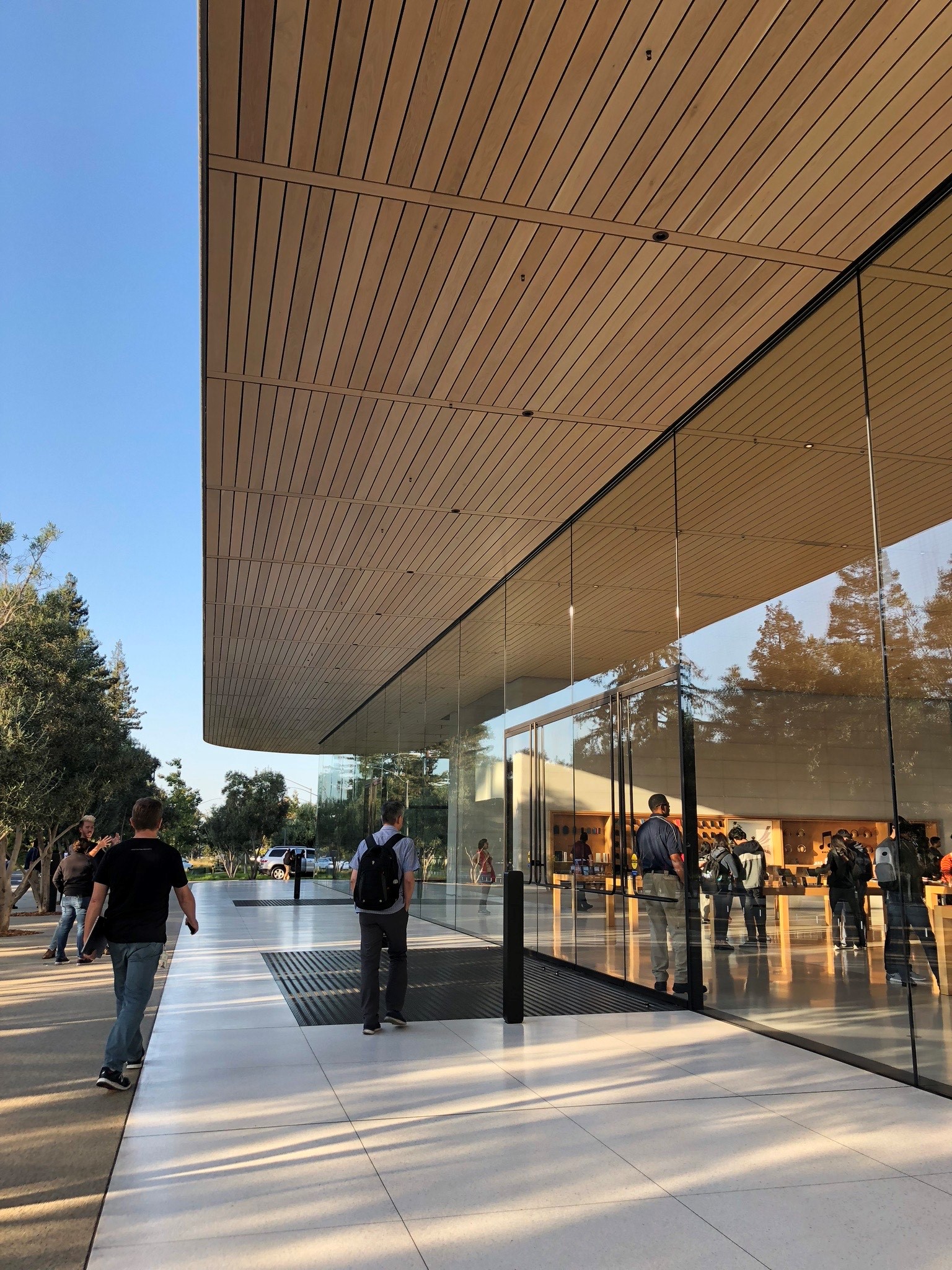 Apple Park exterior shot entrance with visitors walking in and out