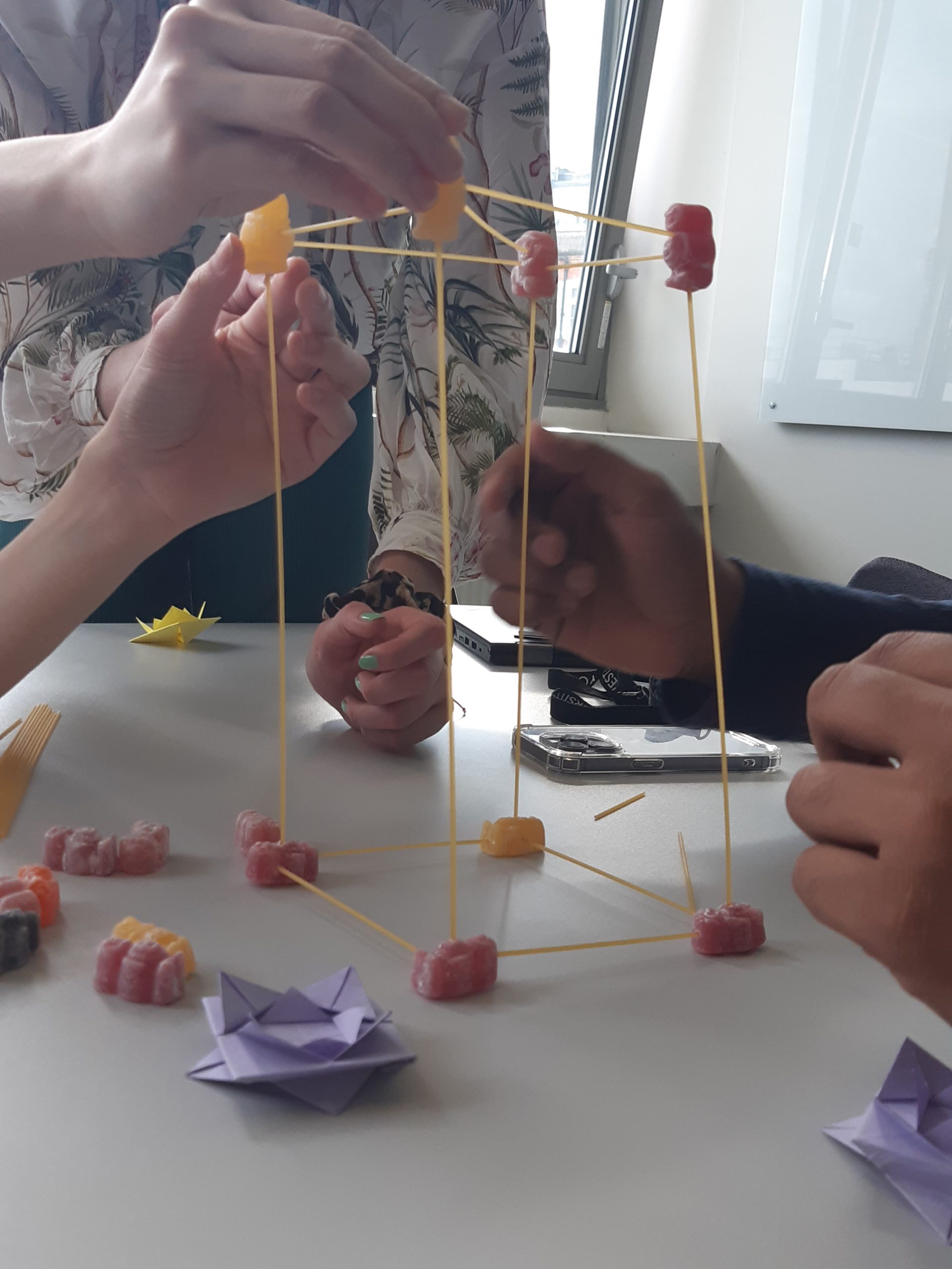 Photo of Business and Psychology students Arrivals Weeks building spaghetti towers in a team building workshop