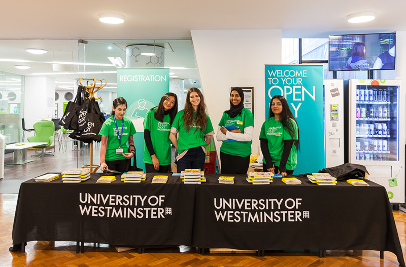 four-smiling-female-student-ambassadors-at-open-day-registartion-desk