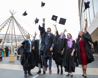 Graduating students throw their hats outside Royal Festival Hall