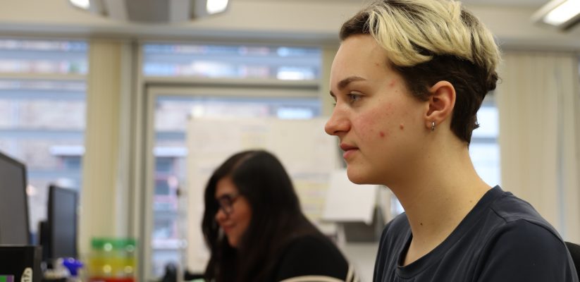 Student sat at a computer in an office