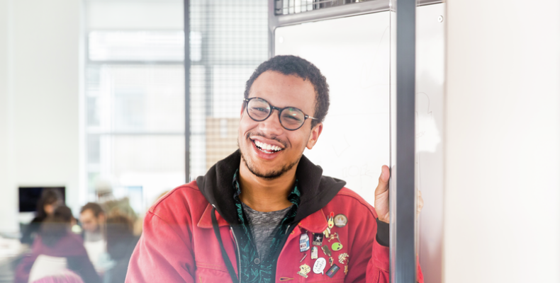 Male student with glasses smiling