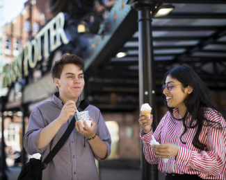 Male and female student eating ice cream outside of BoxPark
