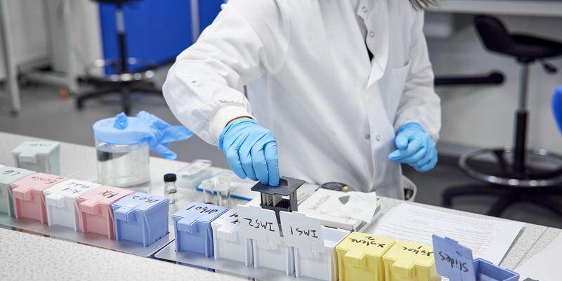 Student wearing a white lab coat in a Science lab