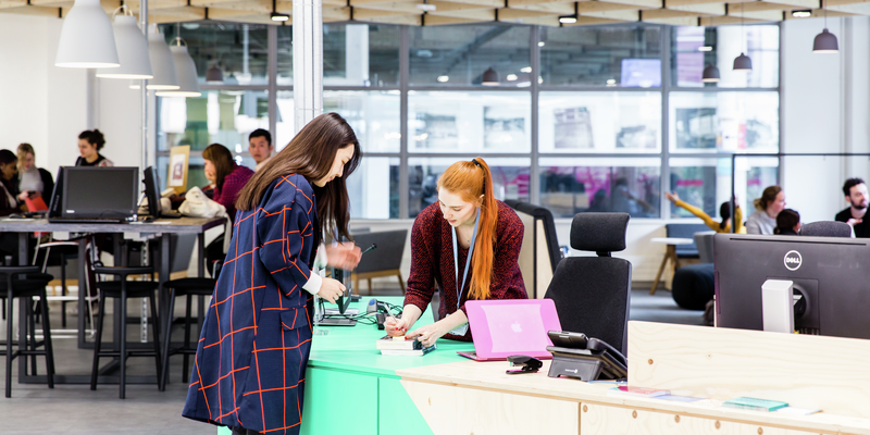 A student approaching the welcome desk at Harrow campus