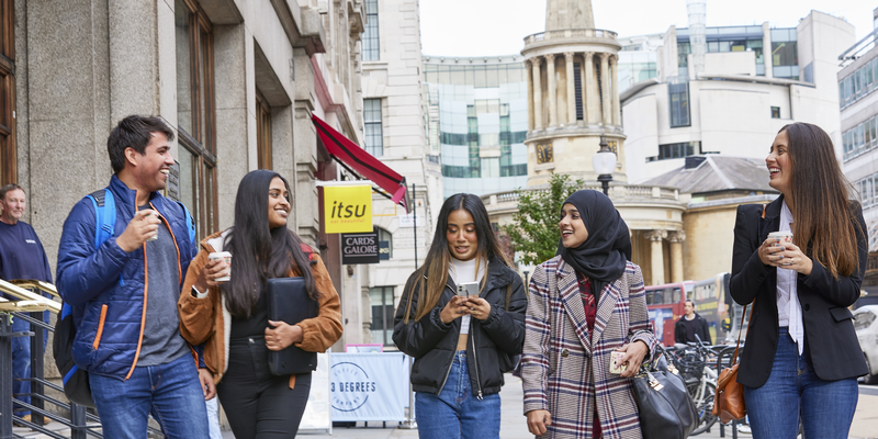 Students walking together on the street in London