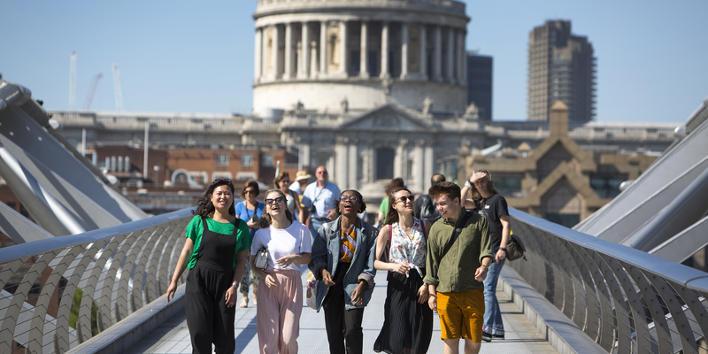 A group students walking together on a bridge