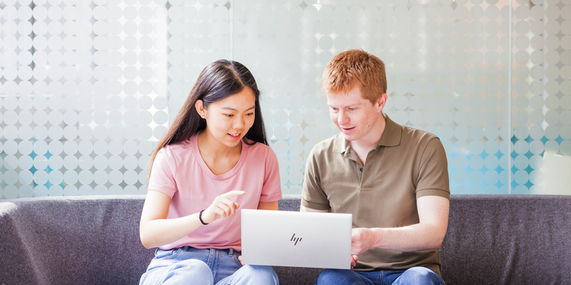 Male-and-female-student-working-on-laptop