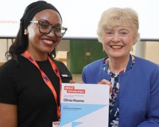 Olivia with academic holding the GREAT Scholarship certificate_From the Office to the Books - 7 Lessons about Returning to Study a Postgraduate Degree_International Student Blog-Olivia Nzomo