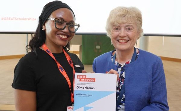 Olivia with academic holding the GREAT Scholarship certificate_From the Office to the Books - 7 Lessons about Returning to Study a Postgraduate Degree_International Student Blog-Olivia Nzomo