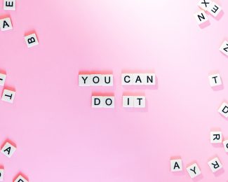Text on a pink background which reads "You Can Do It"