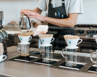 a coffee shop worker making coffee