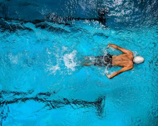 Person Swimming on Body of Water