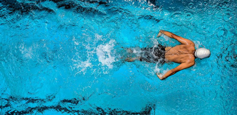 Person Swimming on Body of Water