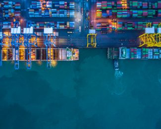Container Port global trade aerial shot including ships, containers and cranes