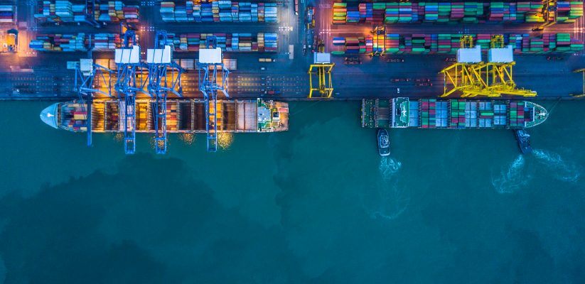 Container Port global trade aerial shot including ships, containers and cranes