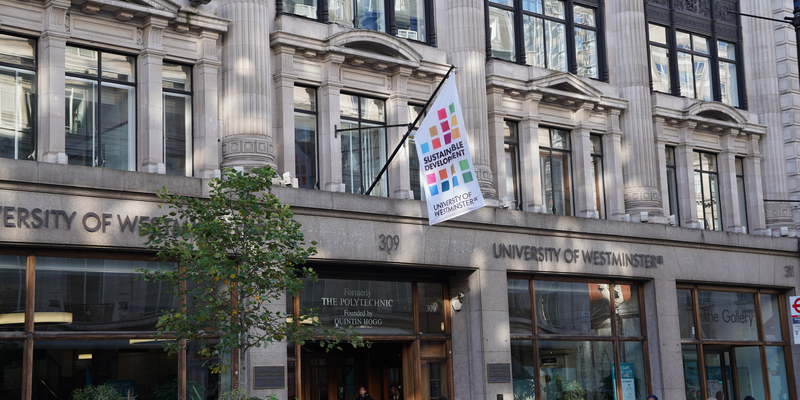 Exterior shot of Regent's Campus with Sustainable Development banner on flagpost - Sustainable Business Challenge